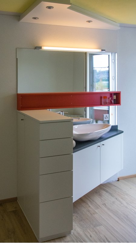 Lavabounterbau und Schubladenstock mit Schieferabdeckung. Wirkungsvolles Detail ist der Baldachin mit stimmungsvollem Licht (dimmbar). Für starkes Licht zum Rasieren und Schminken kann die Leuchtstoffröhre zugeschaltet werden.